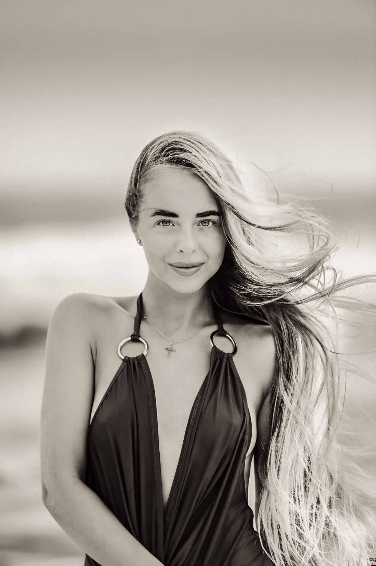 Elegant beach portrait with wind-swept hair in Grand Cayman