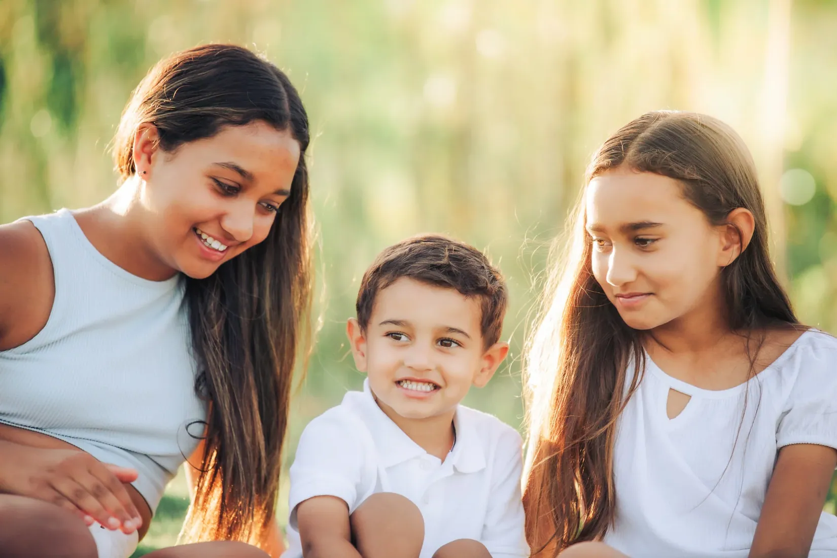 Mother and children smiling together outdoors in Grand Cayman