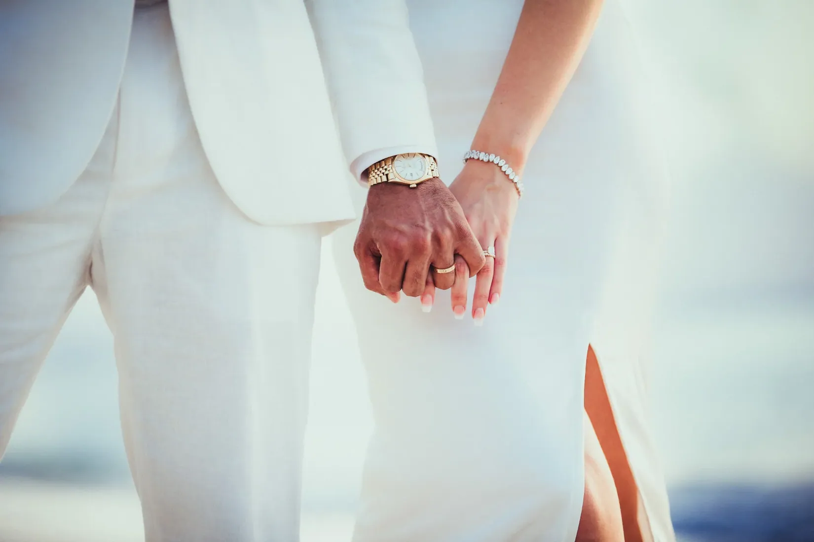 Close-up of a couple holding hands in wedding clothes in Grand Cayman