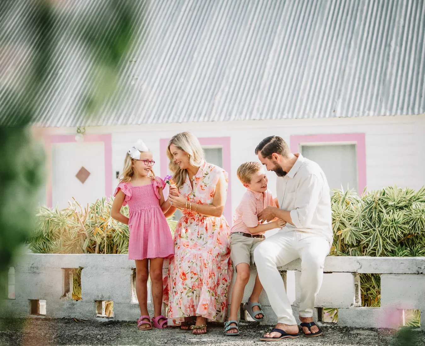 Family together outside a pale house in Grand Cayman