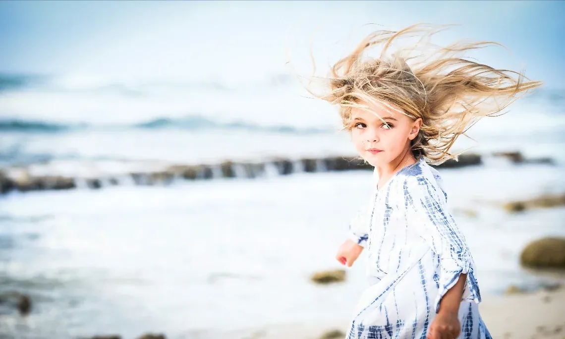 Wind-swept child portrait on a Grand Cayman beach