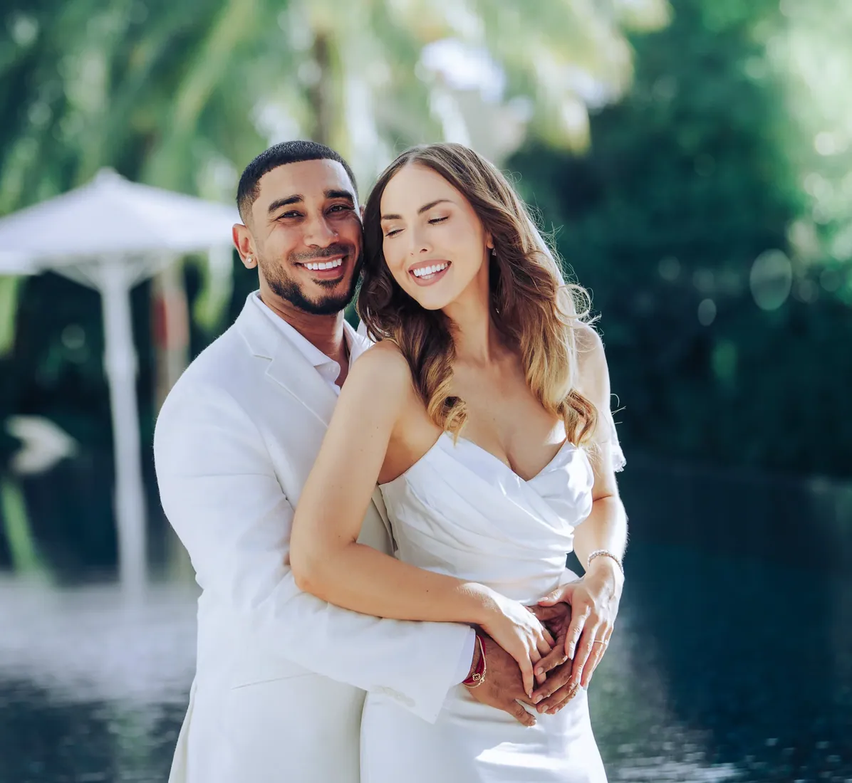 Newly married couple smiling in a tropical garden in Grand Cayman