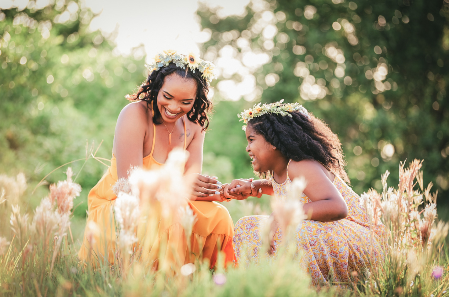 Mother and child playing in tall golden grass