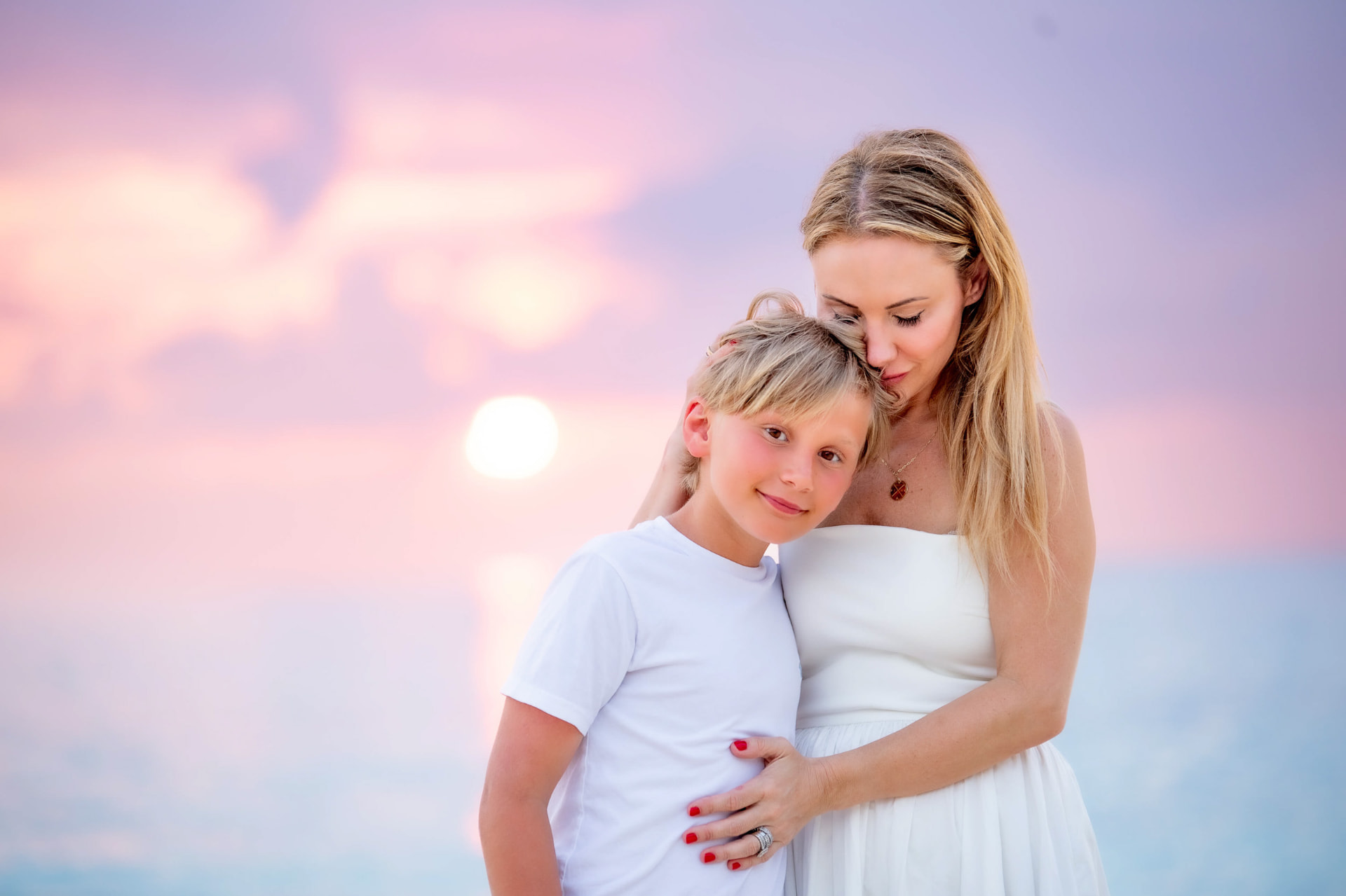 Mother and son in soft pastel sunset light