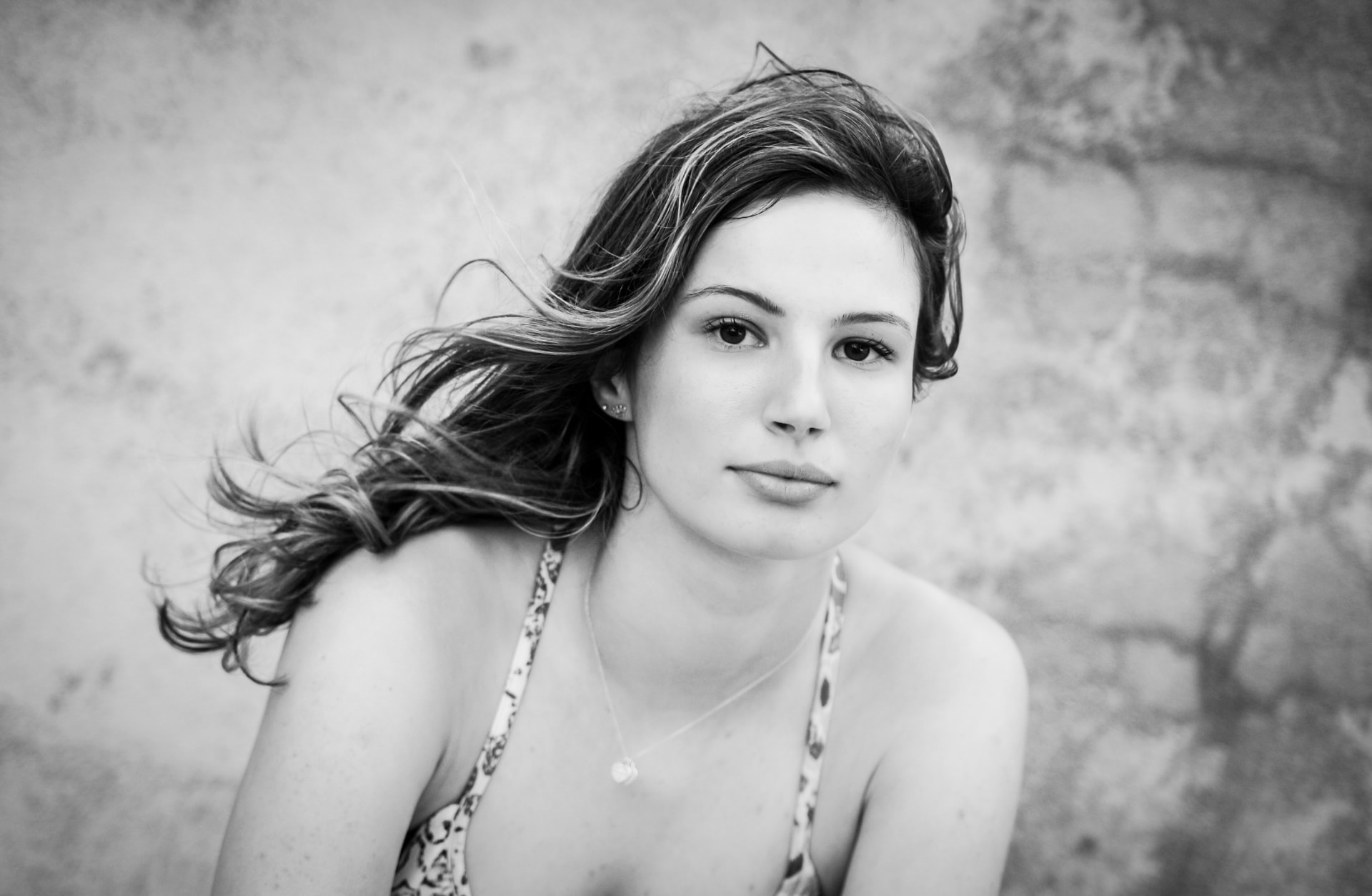 Black and white portrait of a young woman with wind-swept hair