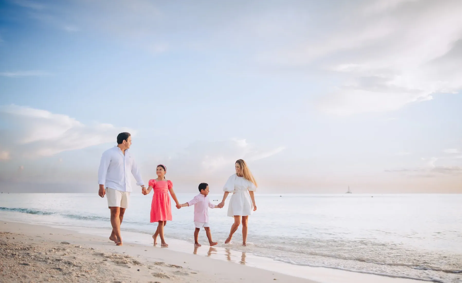 Family walking towards the sea in Grand Cayman