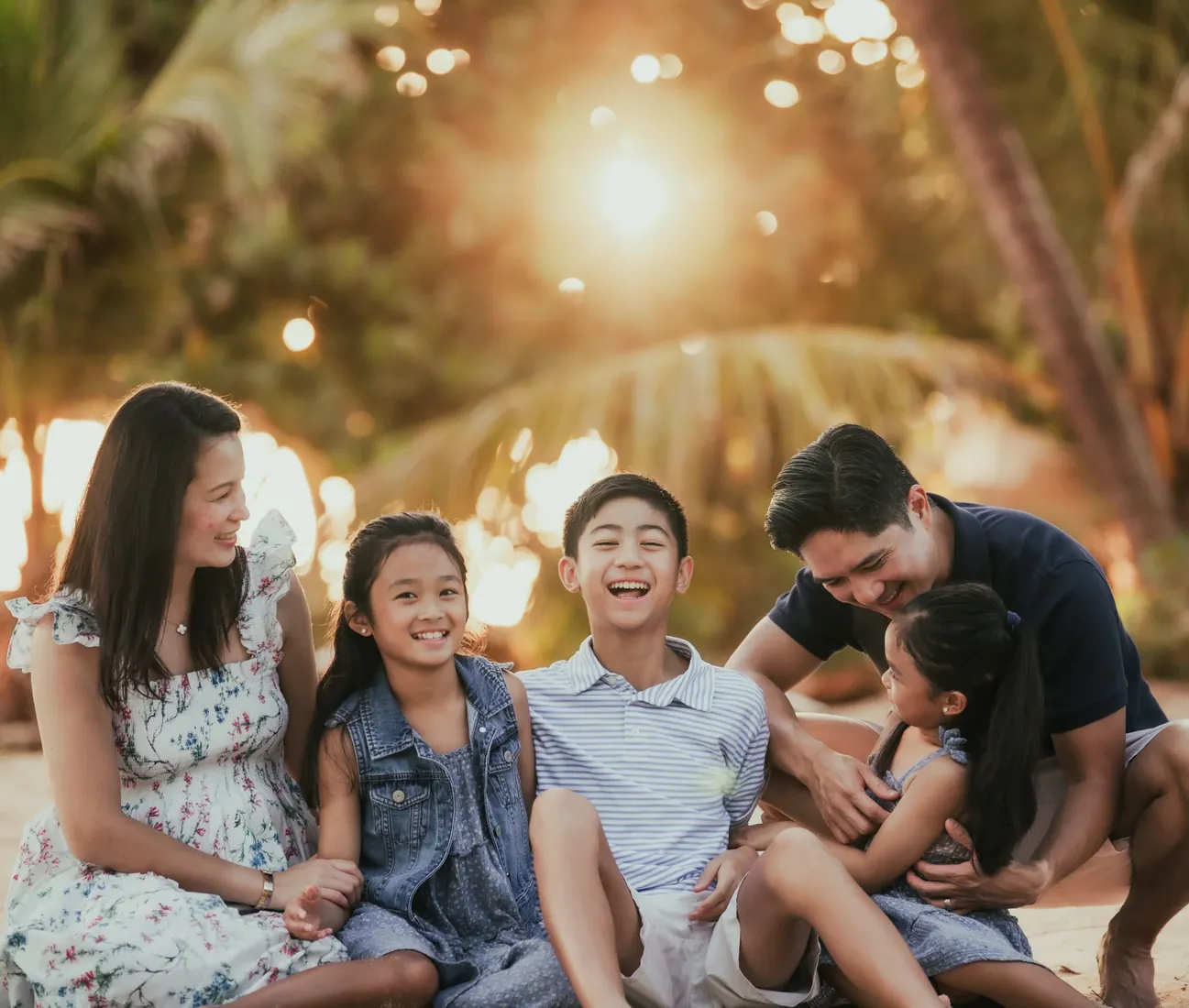 Family smiling together in a leafy garden in Grand Cayman