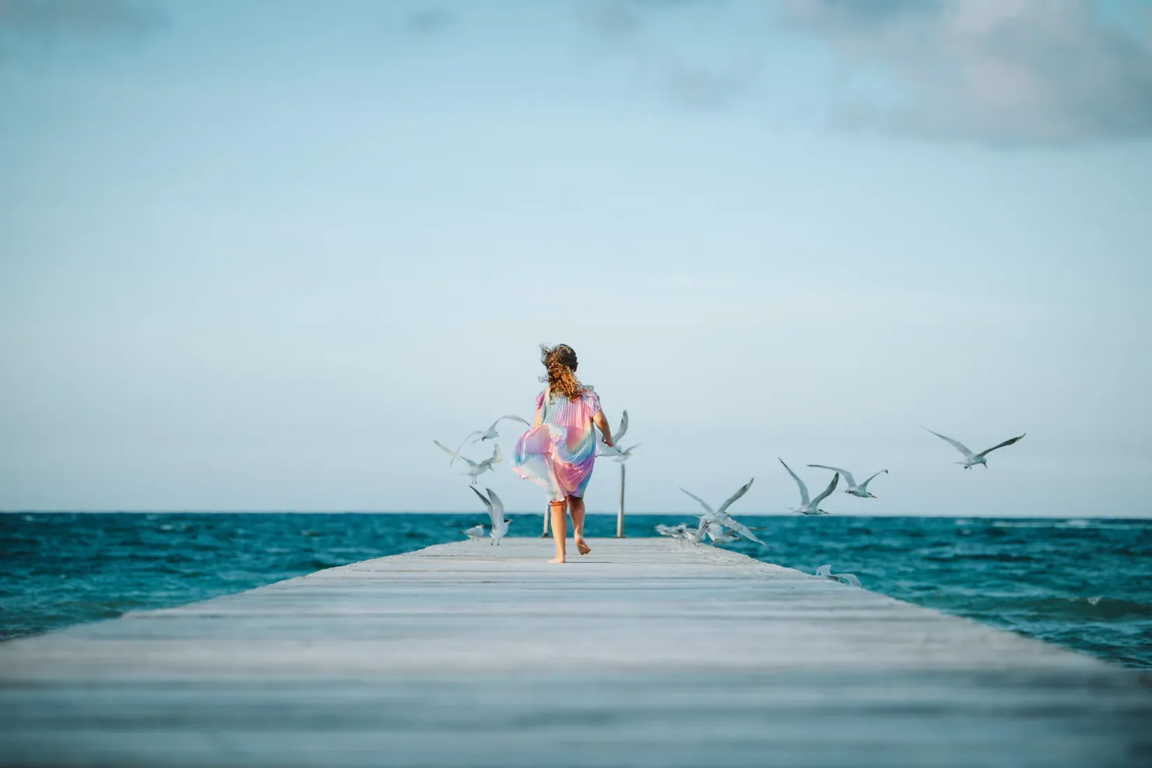 Family standing together at the end of a jetty in Grand Cayman