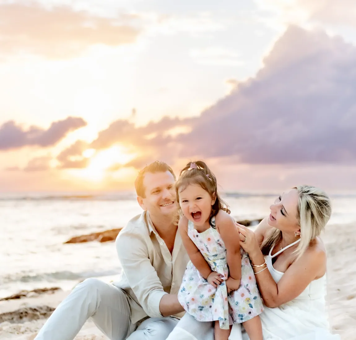 Woman laughing with children at sunset in Grand Cayman
