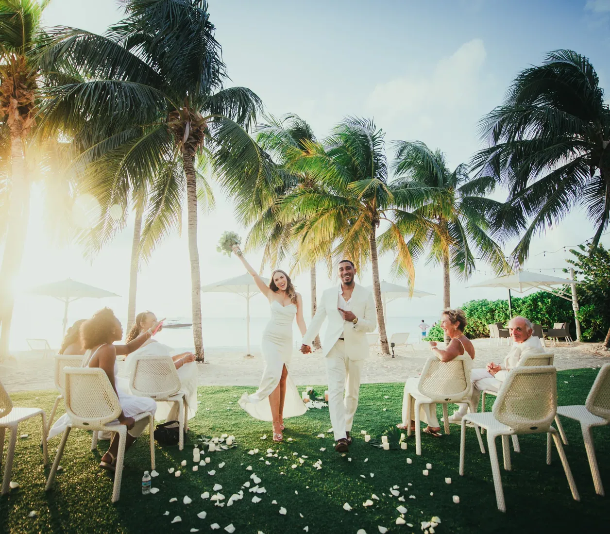 Outdoor wedding ceremony framed by palms in Grand Cayman