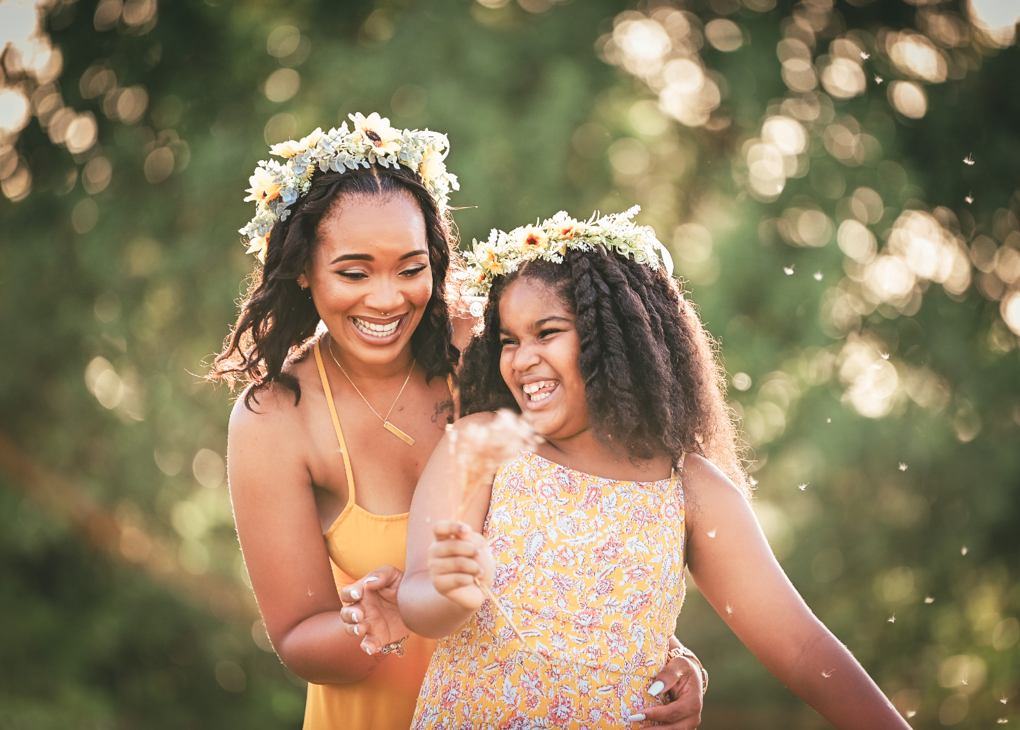 Mother and daughter in flower crowns laughing together in golden Grand Cayman light