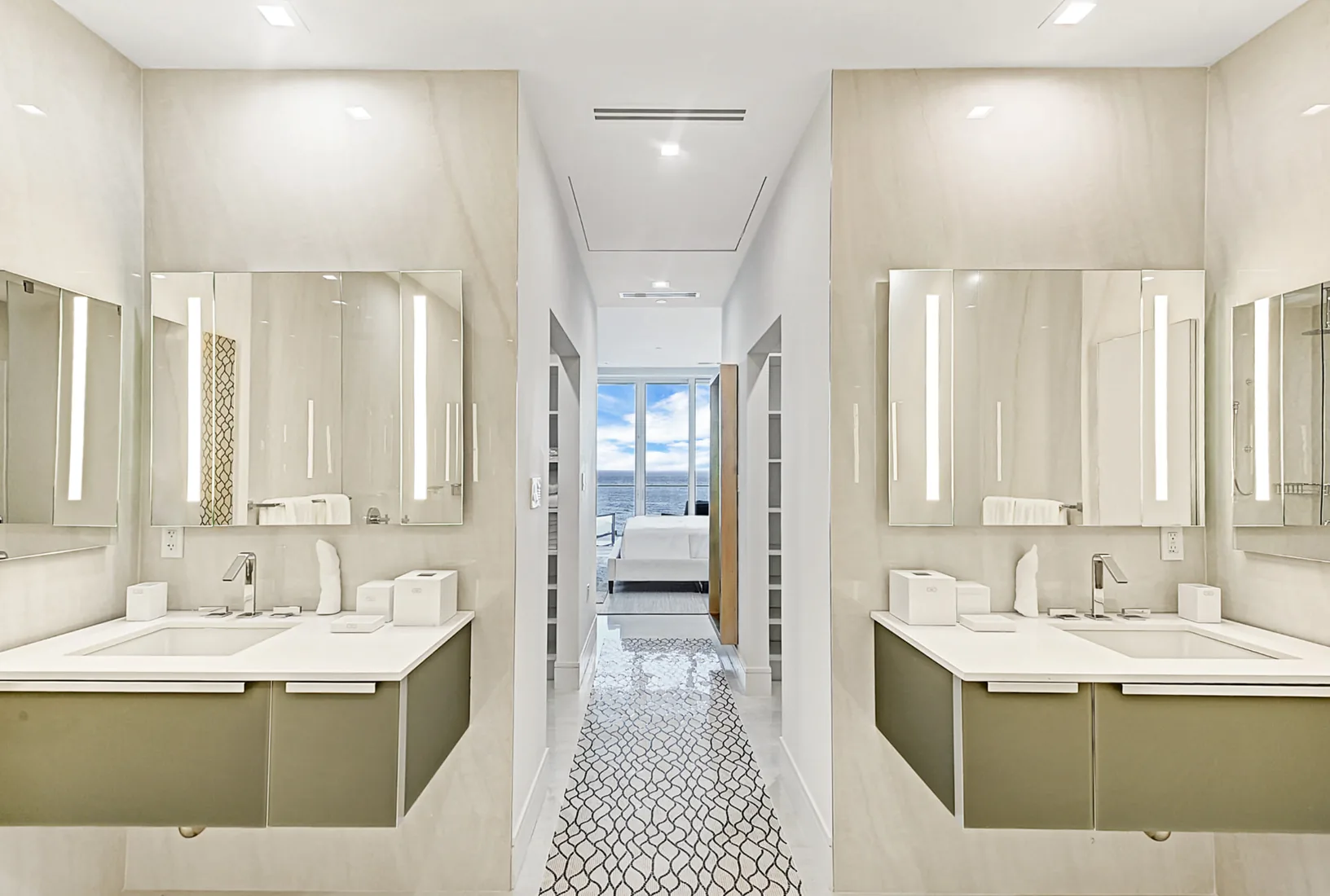 Bathroom with twin green vanities and an ocean-view hallway in Grand Cayman