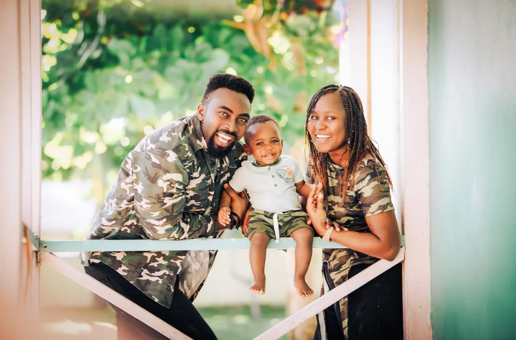 Family laughing beside a garden railing in Grand Cayman
