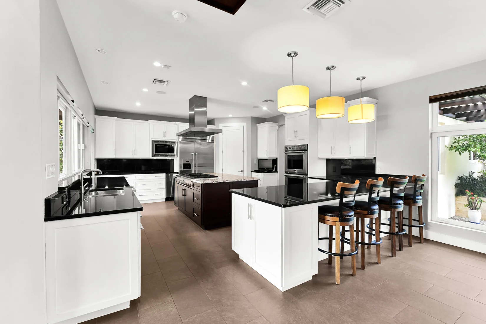 Modern kitchen with black countertops and a breakfast bar in Grand Cayman